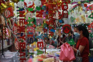 Die Leute durchsuchen Dekorationsartikel für das neue Jahr, die auf dem Sampeng Markt in Bangkok angeboten werden