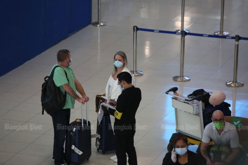 Internationale Passagiere warten bei ihrer Ankunft am Flughafen Suvarnabhumi auf einen Covid-19 Test