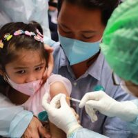 Eine medizinische Fachkraft impft am 17. März in einem Einkaufszentrum in Bankok ein Mädchen gegen Covid-19.