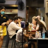Ausländer und Einheimische werden in einer Bar in Bangkok ohne Gesichtsmasken gesehen