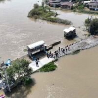 Mitarbeiter des königlichen Bewässerungsministeriums füllten am Mittwoch eine Straße, die durch stark fließendes Wasser geschnitten wurde