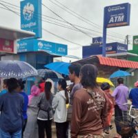 Bewohner des Bezirks Phimai in Nakhon Ratchasima standen im Regen, um Bargeld an Geldautomaten abzuheben. Die Provinz hatte in der ersten Phase der Bargeldvergabe landesweit die meisten Nutznießer.